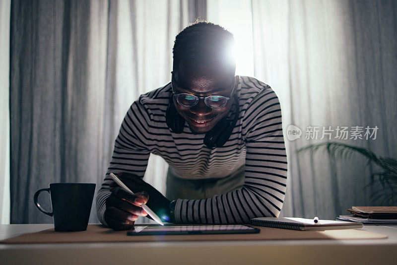 Happy BusinessmanÂ Working At Home On A Digital Tablet